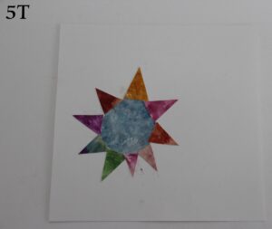 A multicoloured sun from a white backing paper