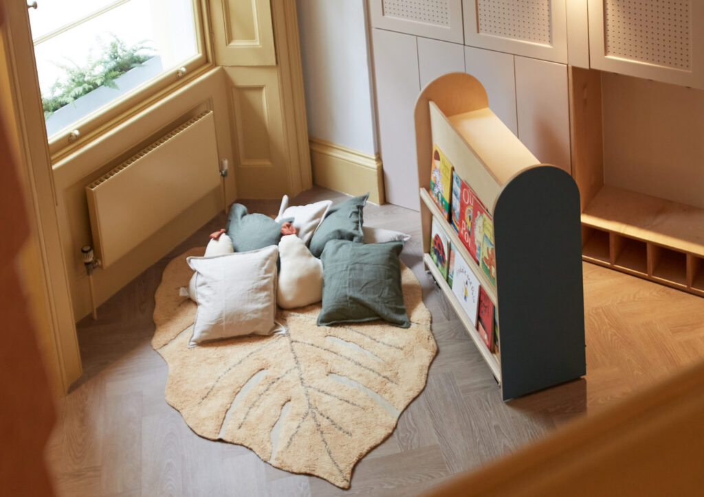 green and white cushions in a book corner