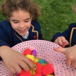 a girl picking a toy