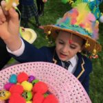 a child picking out a toy from a bonnet