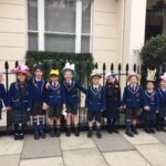 children in bonnets lined up