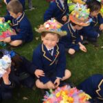 a child in an easter bonnet grinning