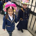 girls wearing easter bonnets outside