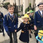 children wearing easter bonnets outside