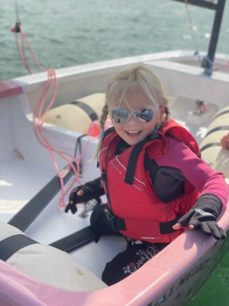 a girl sitting in a sail boat