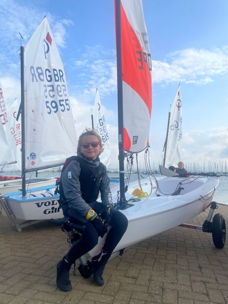 a child sitting on a sail boat