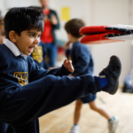 boy kicking a bat