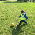 a boy kicking a ball