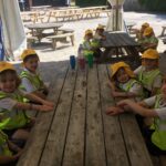 children sitting at a wooden table