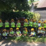 children in high visibility jackets and hats